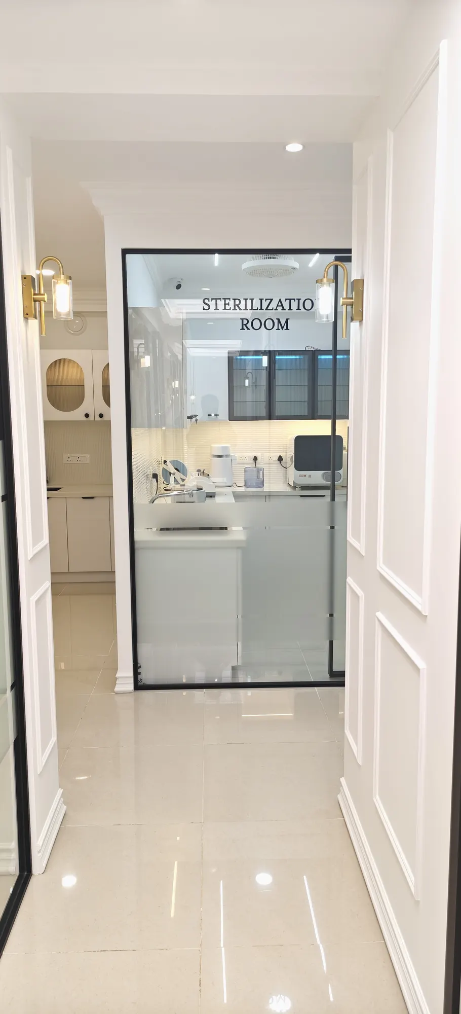 The glass-fronted sterilisation room at the end of a corridor